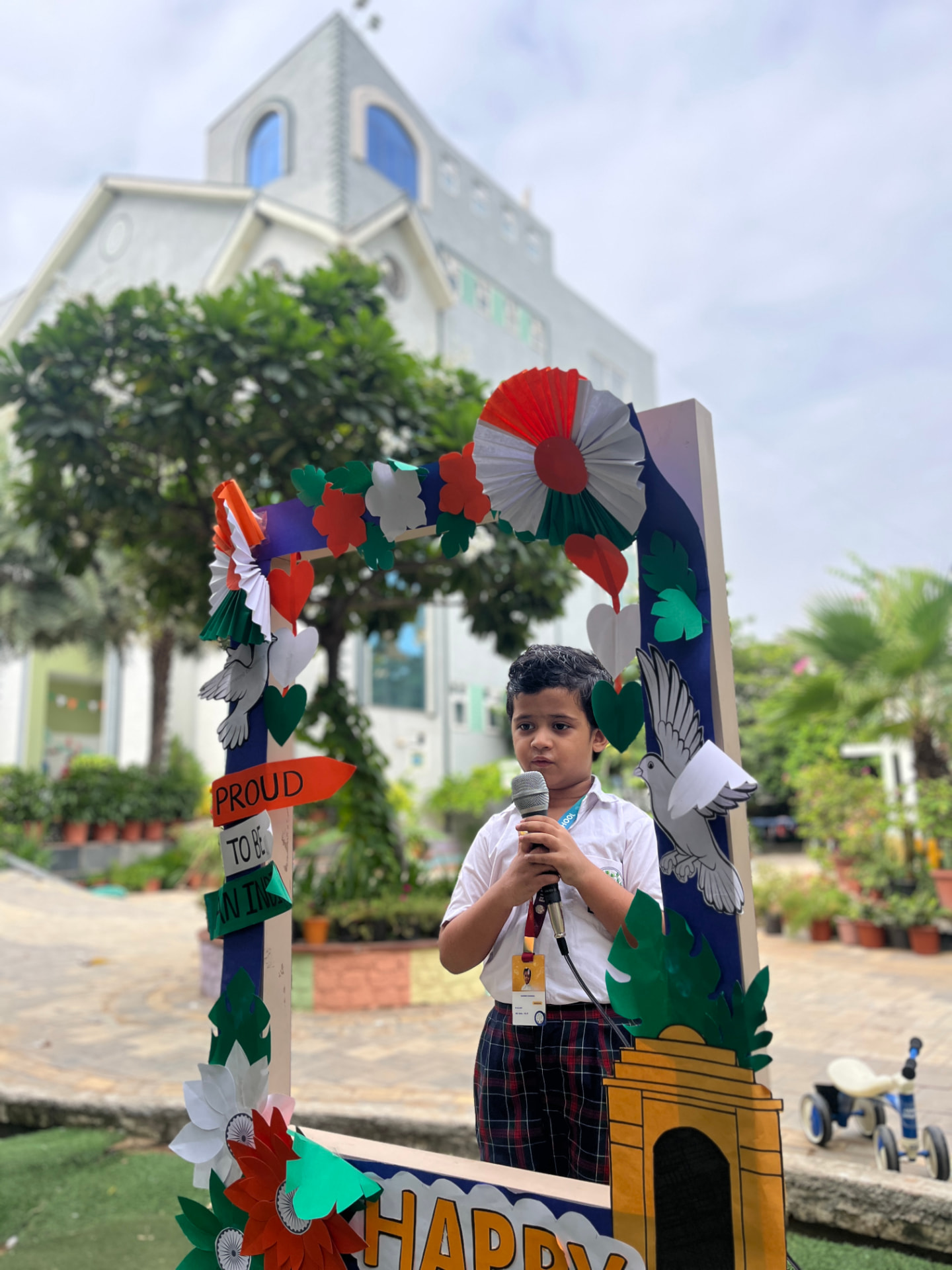 Student speaking on the mic at an Independence Day celebration