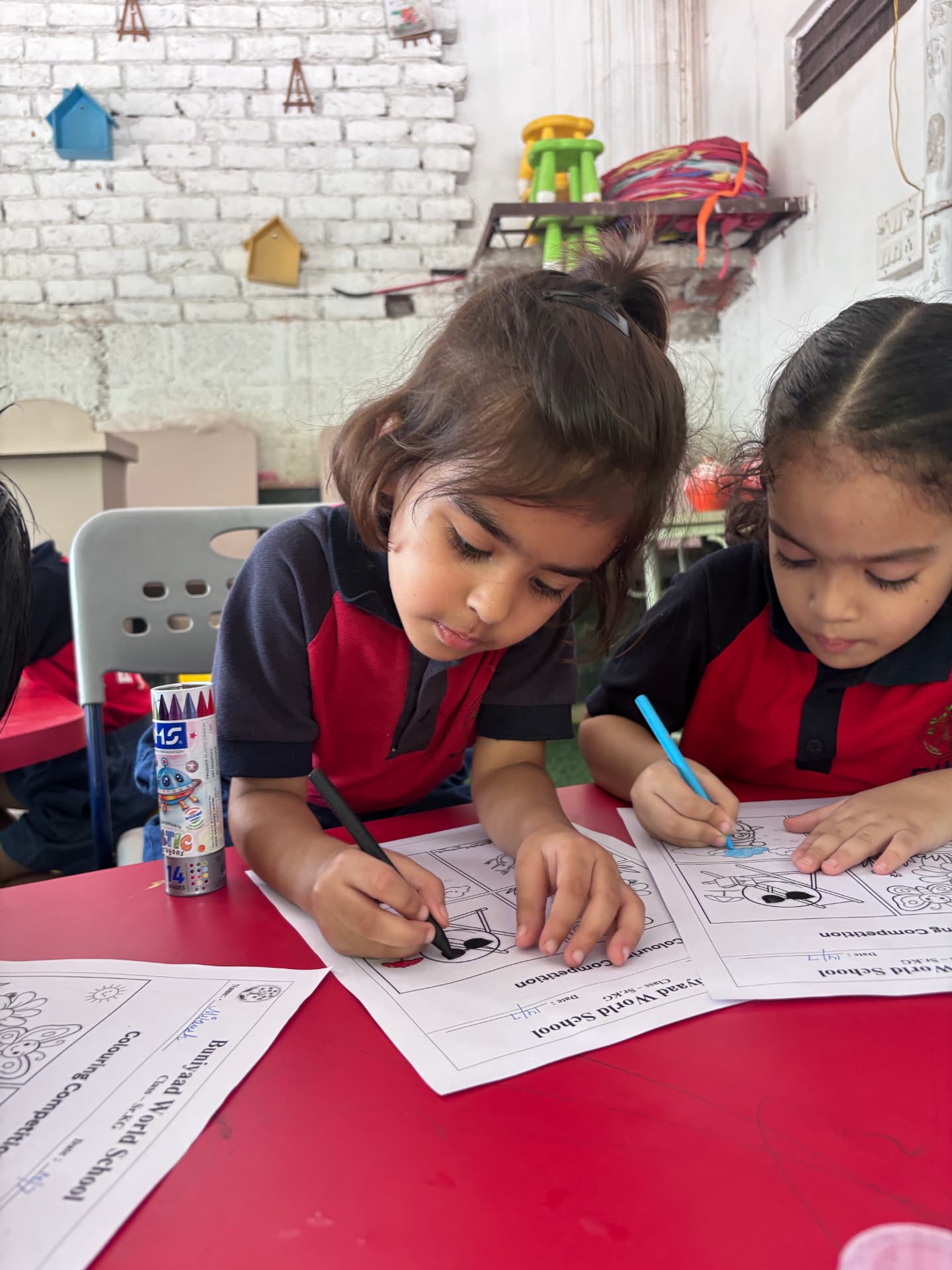 Students at Buniyaad World School taking part in a classroom colouring activity